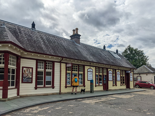 A small black terrier dog at Aviemore Station.